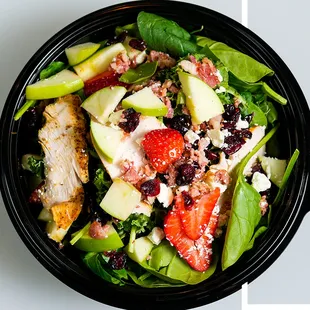 THE FORBIDDEN FRUIT Chicken, bacon, feta cheese, fresh strawberries, apples, and craisins. Topped with walnuts.