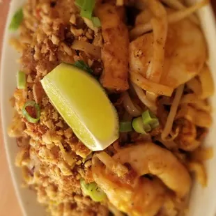a plate of fried rice with shrimp and vegetables