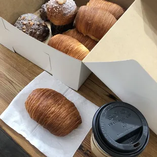 a box of croissants and a cup of coffee