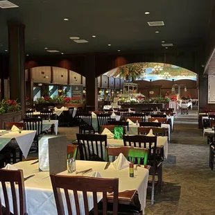 tables and chairs with white tablecloths