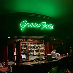 a neon sign above the bar