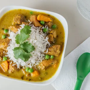 a bowl of stew with rice and vegetables