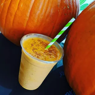 a pumpkin smoothie next to a pumpkin