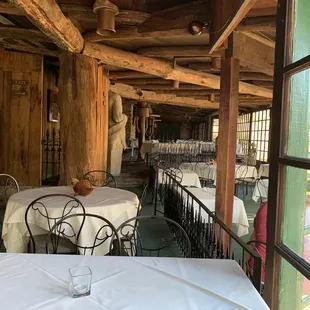 tables and chairs with white tablecloths