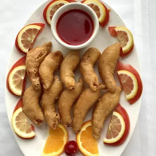 a plate of sliced gingers and a cherry