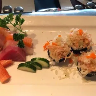 a plate of sushi and vegetables