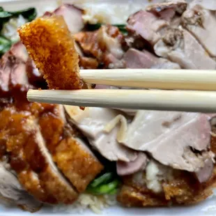 Siu yuk aka roast pork belly. Got the three choices of meat (roast pork belly, char siu (bbq pork), and roast duck) over rice. $8