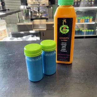 two bottles of juice on a counter