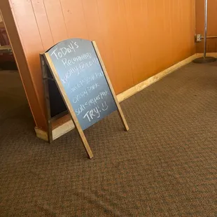 a chalkboard sign in a restaurant