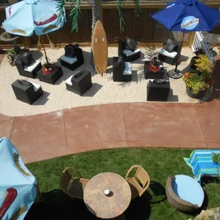 Green Kayak Backhouse Beachclub courtyard. Features beach seating, grass seating, fire pit, fountain and more.....
