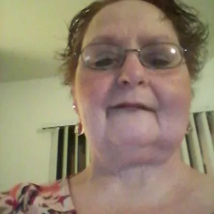 a woman with glasses smiling