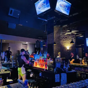 a bar filled with people watching televisions