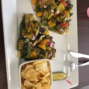 a plate of food with chips and salsa