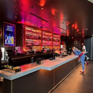 a woman standing at a bar