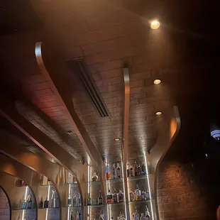 a bar with shelves full of liquor bottles