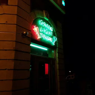 a neon sign for a green light tavern