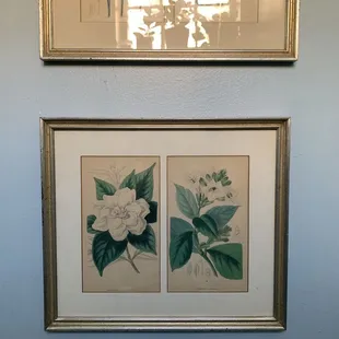 painting hung up in the bathroom