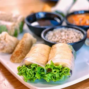 a plate of food with dipping sauces