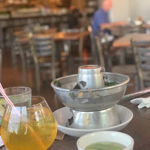 a glass of juice and a bowl of soup