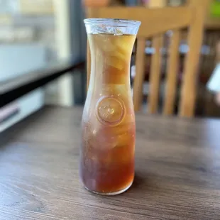 a glass of iced tea on a table