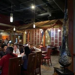 a group of people sitting at a table in a restaurant