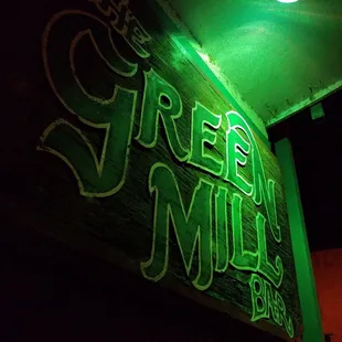 the neon sign for the green mill