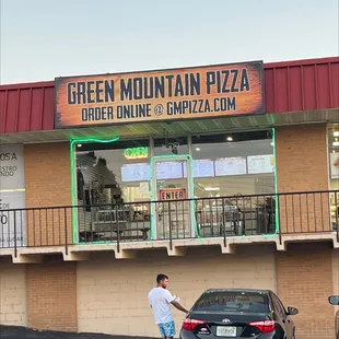 a man standing in front of a restaurant