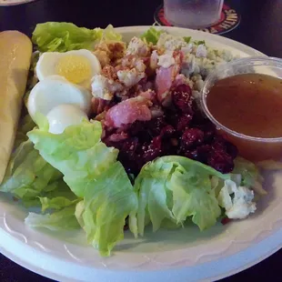 Cranberry Bog salad with bleu cheese, pecans, bacon, chicken, and half of a hard boiled egg. Hot bacon dressing. Delicious.