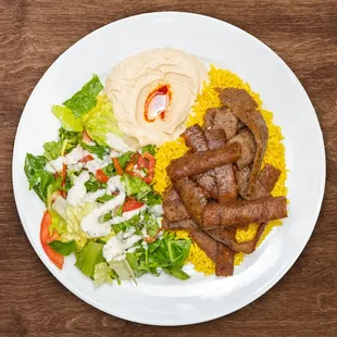 a plate of food with meat and vegetables