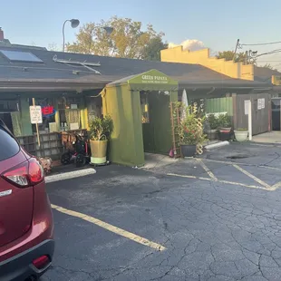 a parking lot with a red car parked in front of it