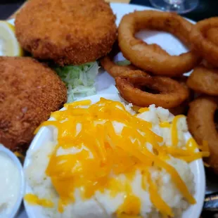 Crab cakes encrusted in cornflakes and a side of cheese grits and onion rings