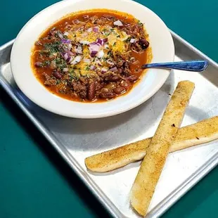 a bowl of chili and bread