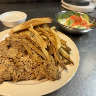 Chicken Fried Steak dinner with white gravy and a small salad
