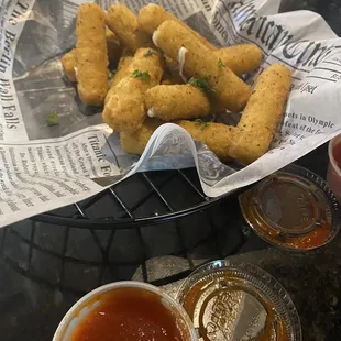 a basket of deep fried tater tots and dipping sauce
