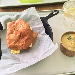 a croissant sandwich and soup