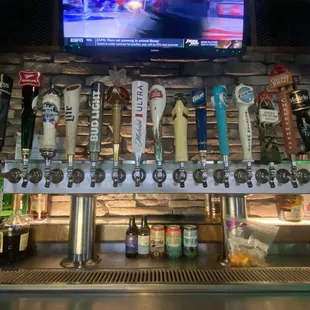 a row of beer taps on a bar