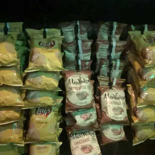 a shelf full of chips and snacks