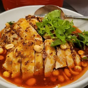 a bowl of soup with meat and beans