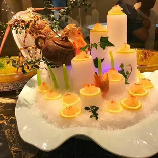 a cake with candles and lemon slices