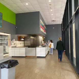 a woman walking through a cafeteria