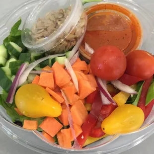 Rainbow Salad: mixed greens, bell peppers, cucumbers, carrots, tomatoes, red onion, sunflower seeds &amp; a tomato onion vinaigrette. (Vegan)