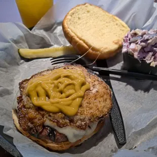 Sirloin burger with fried egg and Swiss. Creamy coleslaw on the side.