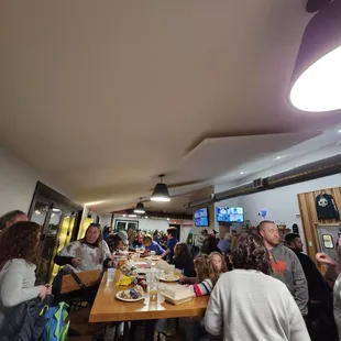 a large group of people sitting at a long table