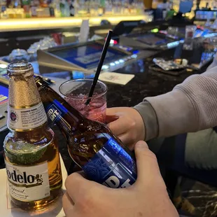 a man holding a beer and a drink