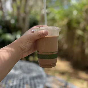 a hand holding a cup of coffee