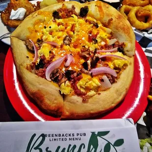 a pizza on a red plate
