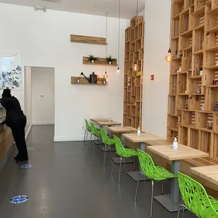 a person standing in a room with wooden shelves