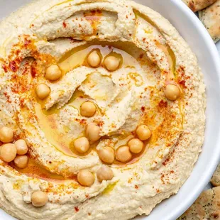 a bowl of hummusle and pita chips