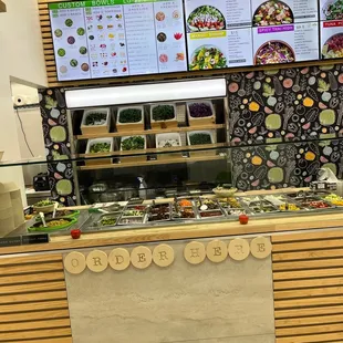 a restaurant counter with a variety of food items