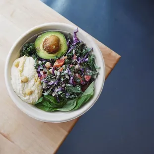 a bowl of food on a wooden table
